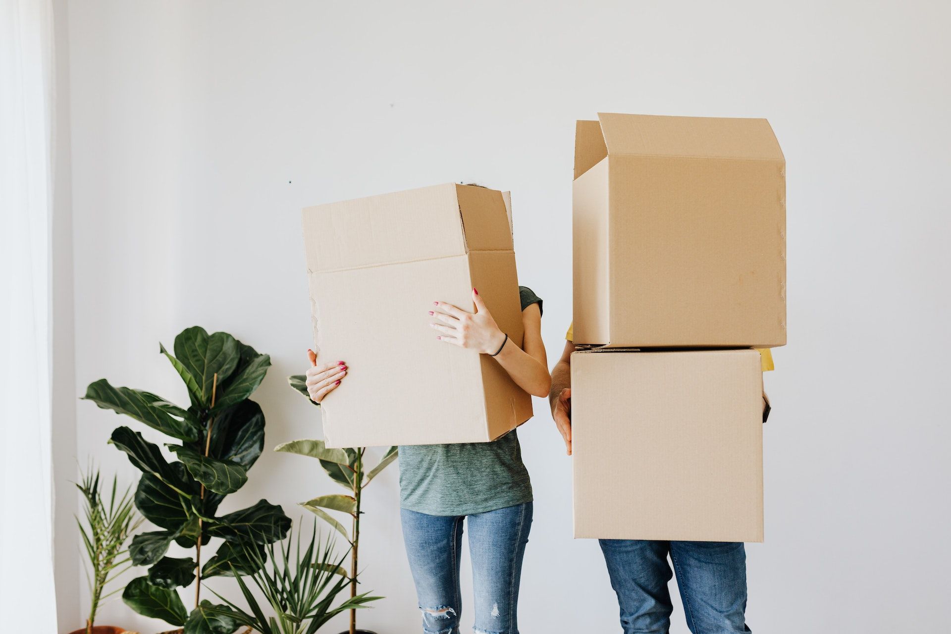 Photo of two people moving boxes.